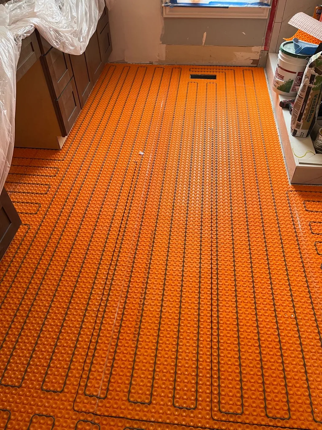 Heating cables secured to the floor membrane during installation of a heated floor system, master bathroom remodel, Metro Atlanta