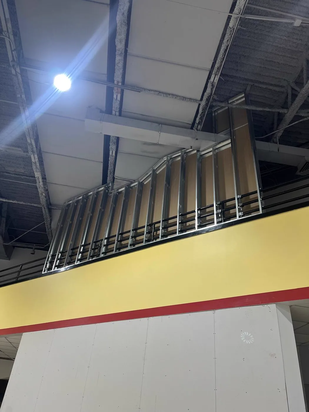 Steel stud framing built up to ceiling height during a commercial venue renovation, Metro Atlanta