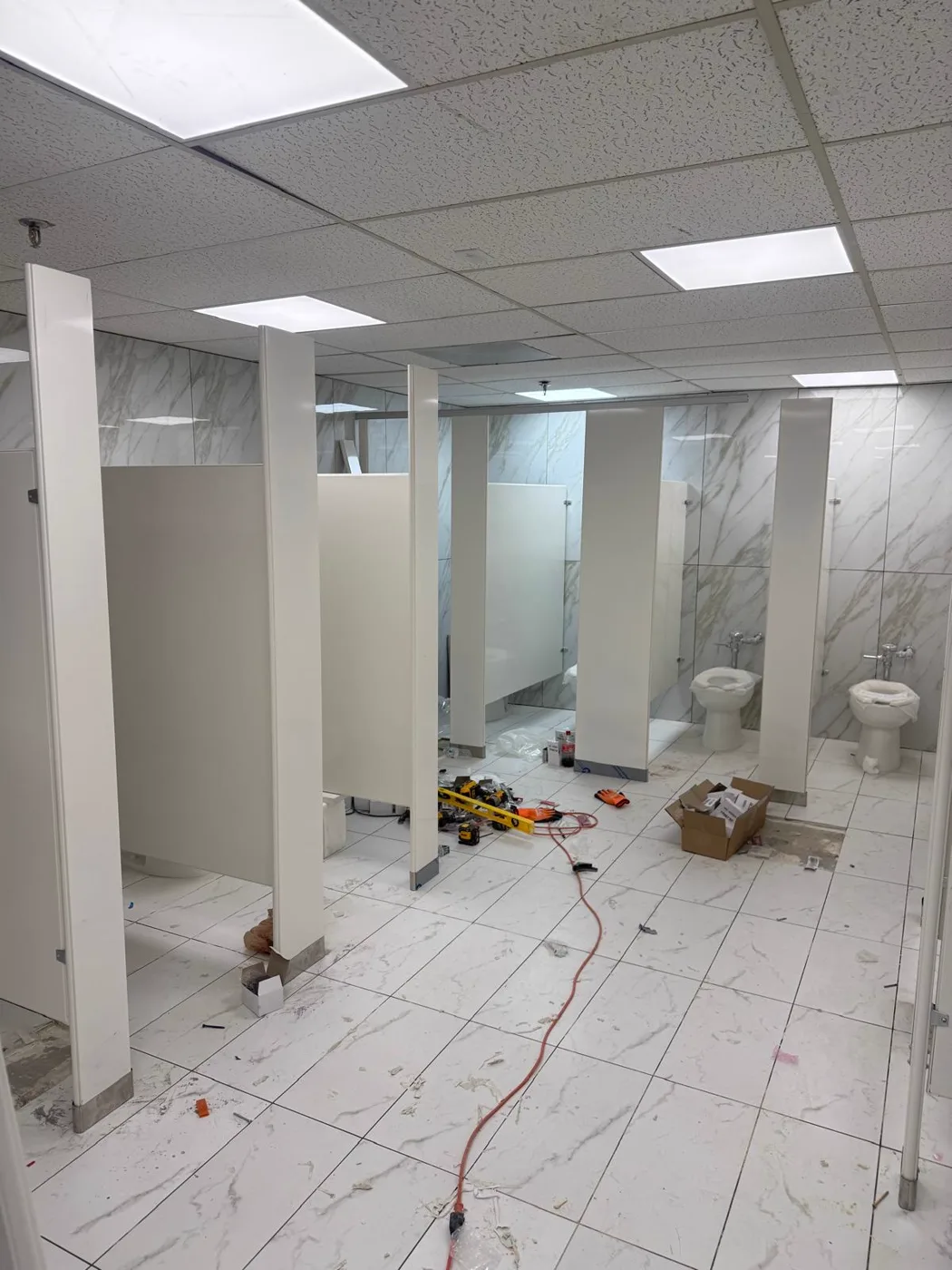Restroom partitions being installed during a commercial venue renovation, Metro Atlanta