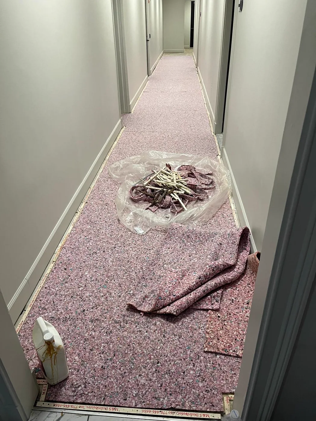 Old carpet being torn out of a corridor before a commercial venue renovation, Metro Atlanta