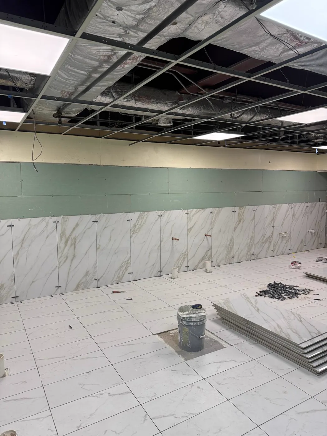 Marble wainscot walls being installed during a commercial venue renovation, Metro Atlanta