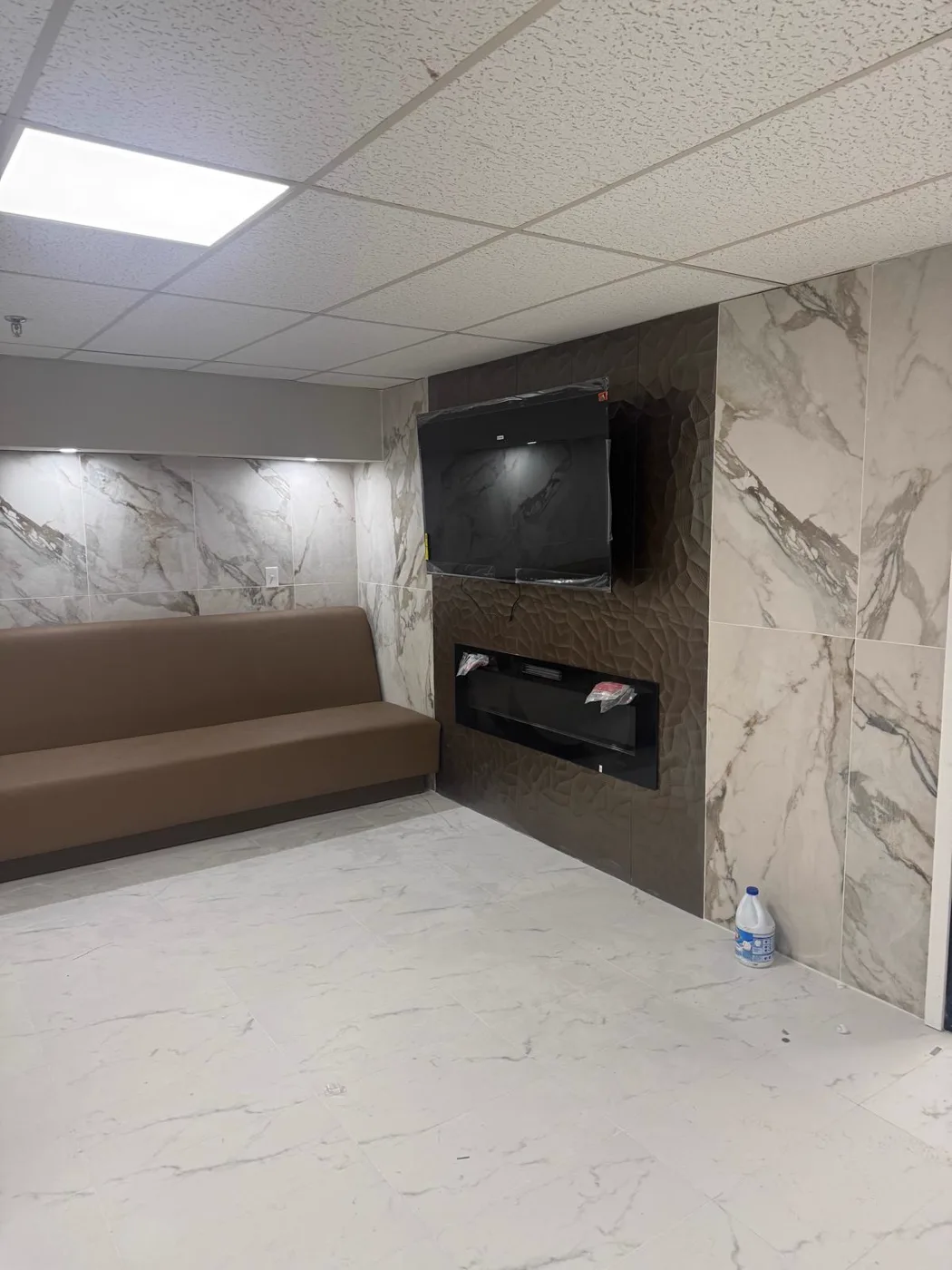 Finished waiting area with marble walls and a sofa, commercial venue renovation, Metro Atlanta