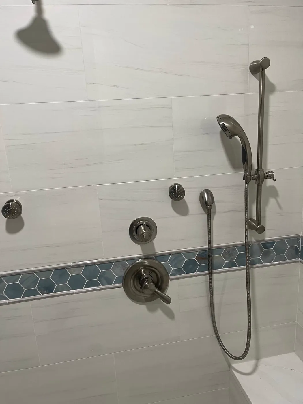 Finished shower with body sprays, handheld sprayer and a hexagon tile accent band, Metro Atlanta