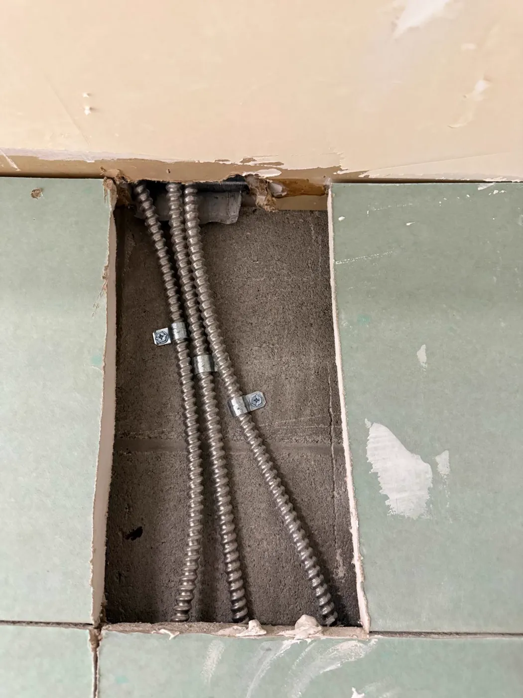 Flexible metal conduit runs secured inside an open wall cavity, Metro Atlanta
