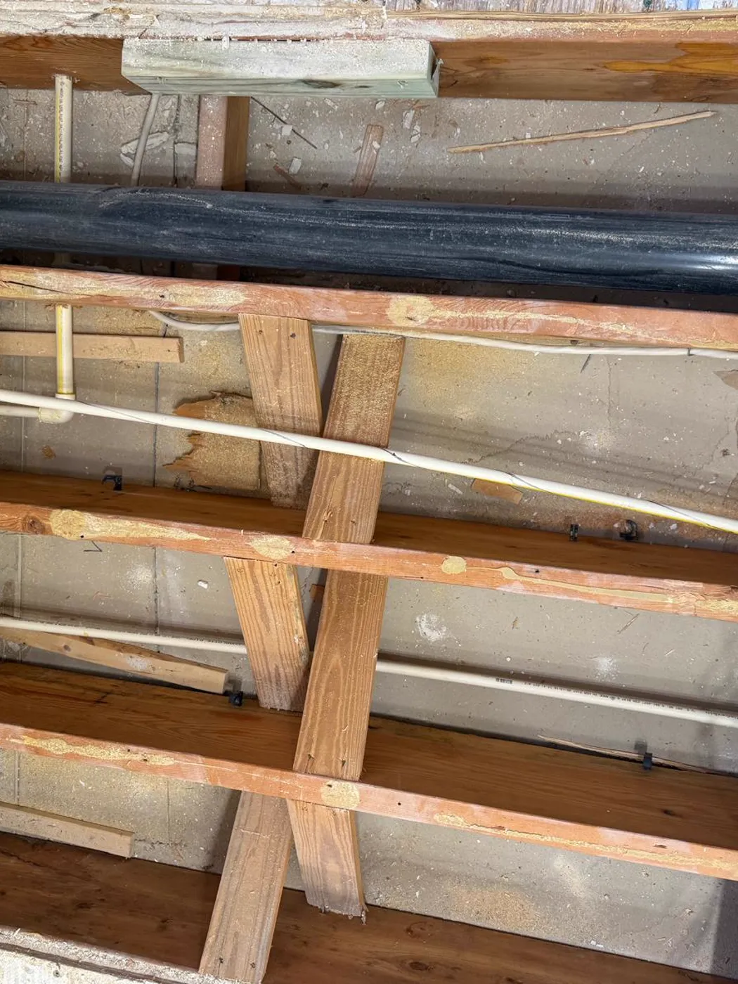 New plumbing lines run through floor joists during a renovation, Metro Atlanta