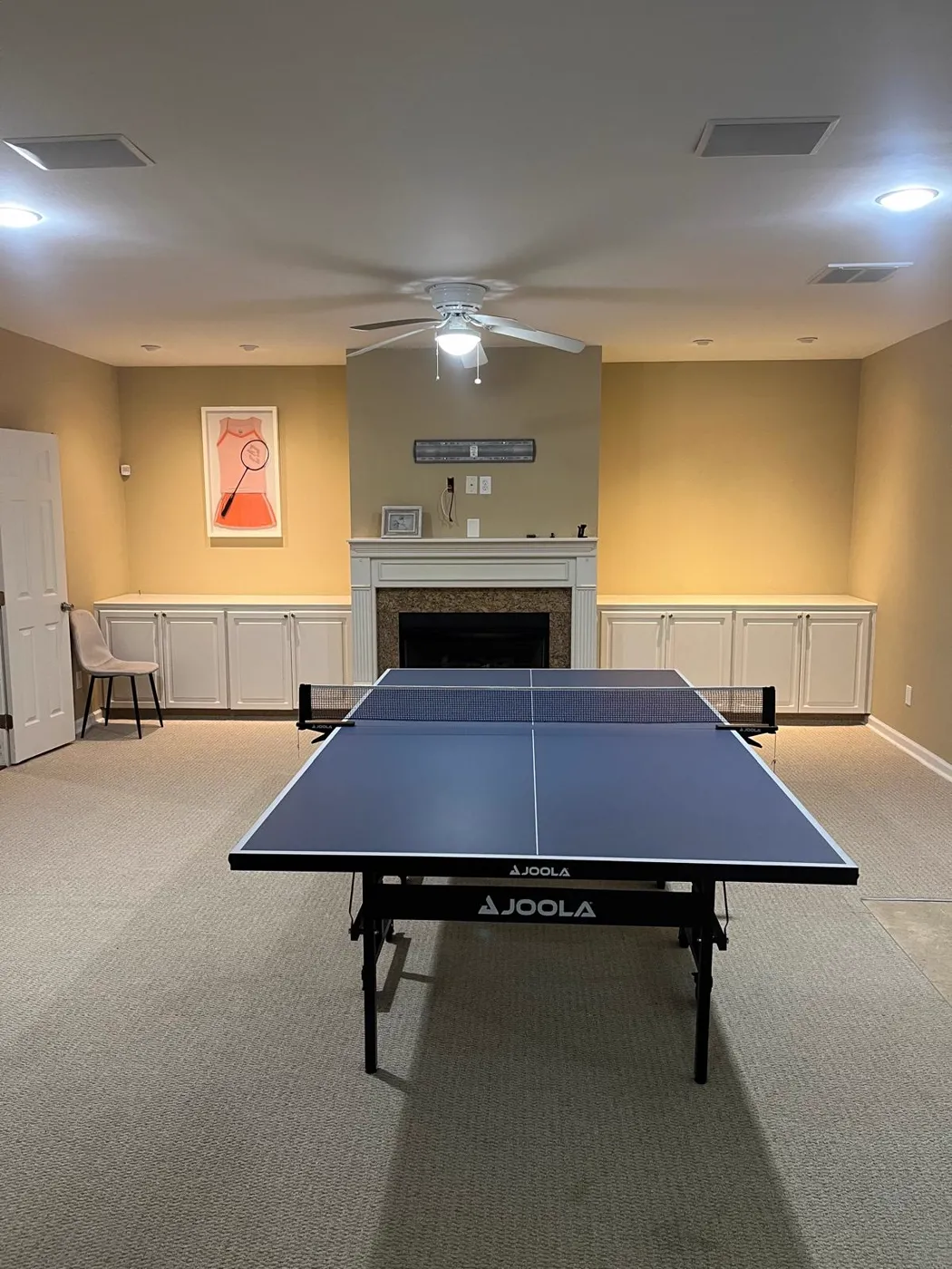 Finished recreation room with a fireplace, built-in cabinetry and recessed lighting, Metro Atlanta