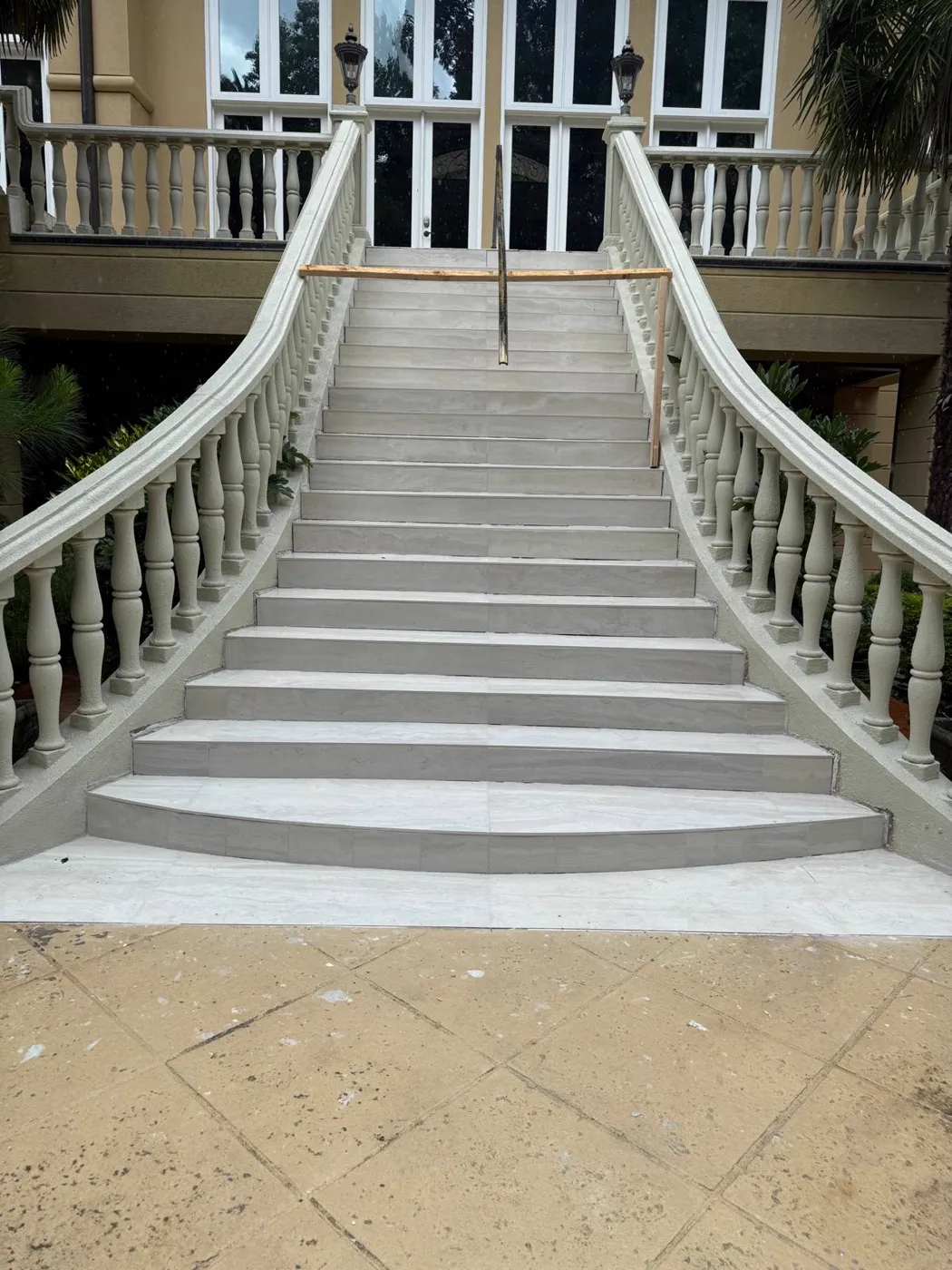 Finished curved exterior double staircase with balustrades and a stone finish, Metro Atlanta