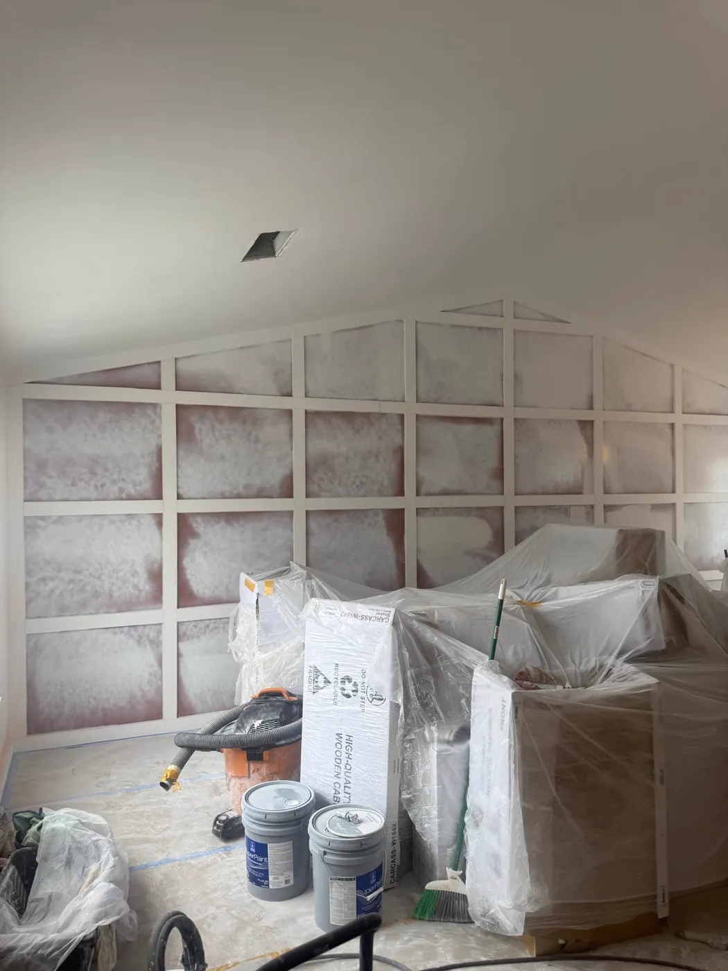 Wall panel grid being installed and primed over an existing wall, Metro Atlanta